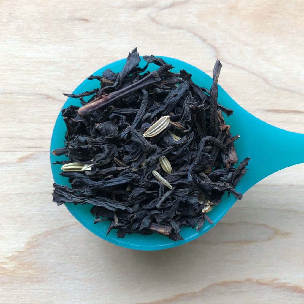 A spoonful of blended black tea with fennel seeds