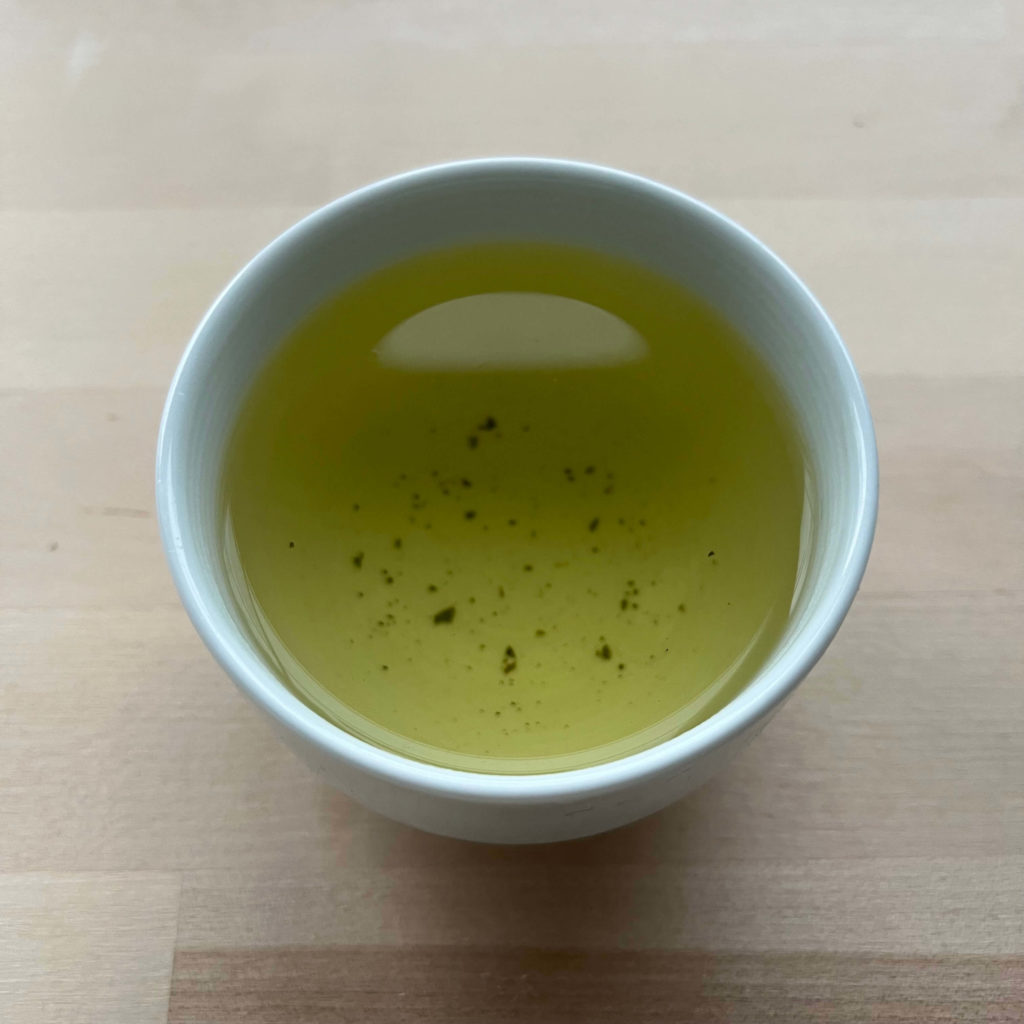 Cup of yellow-green liquor